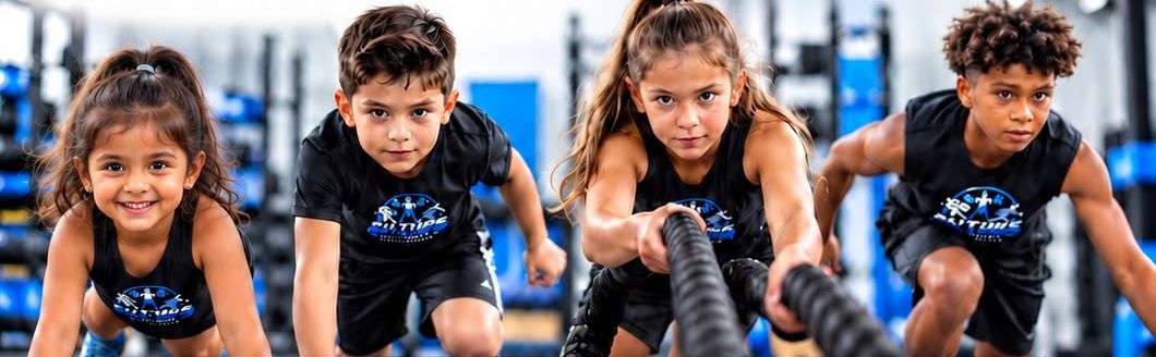 Four kids in Future Champs shirts at the start of a workout, one pulling battle ropes